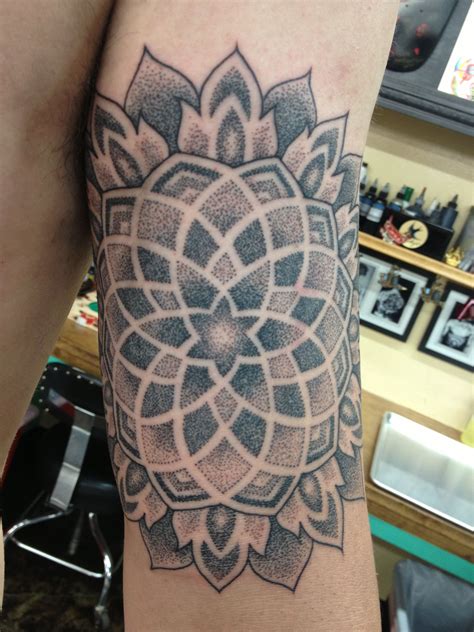 These tattoos hold deep significance, representing the universe and existence in Hindu and Buddhist traditions. . Dotwork mandala tattoo